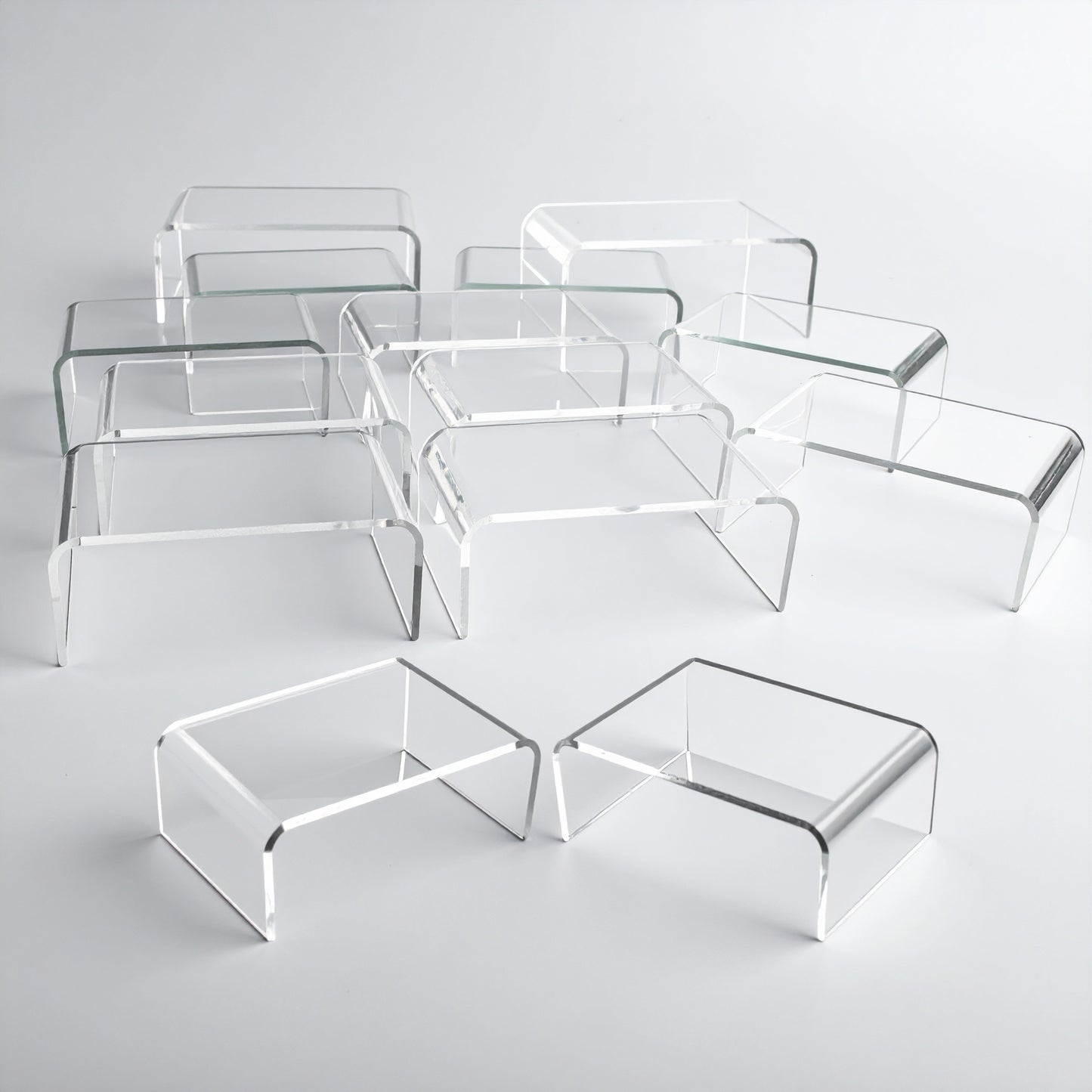 Mini Acrylic Riser Set — Clear — Set of 12 – clear acrylic display stand for retail, showroom, or countertop use, size . Made in the USA by WebAcrylics.