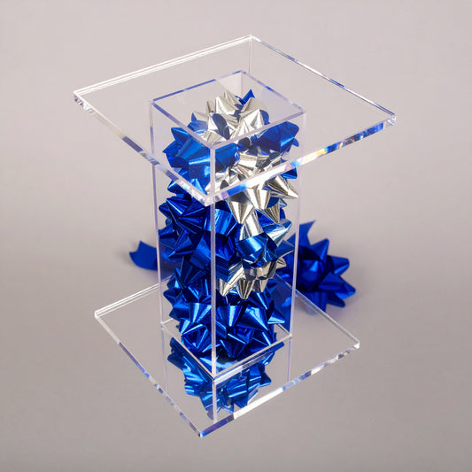 Bow Pedestal Stand — Clear Acrylic Event Riser – clear acrylic display stand for retail, showroom, or countertop use, size 4 x 4 x 4. Made in the USA by WebAcrylics.