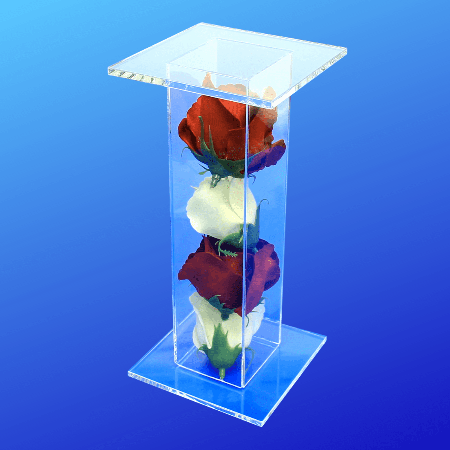 Pedestal display stand filled with red and white roses