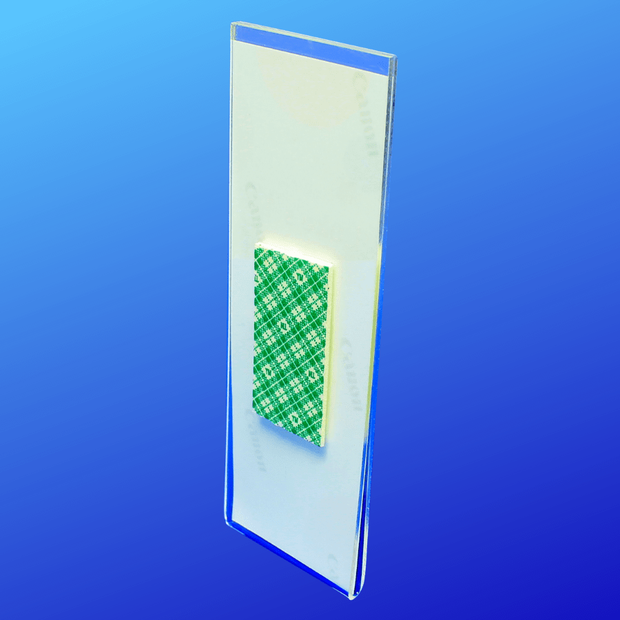 Back side of acrylic photo booth frame with double-sided tape for displaying on walls
