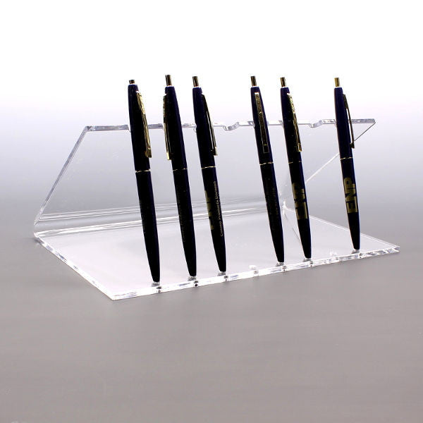 Acrylic stand holding multiple pens upright
