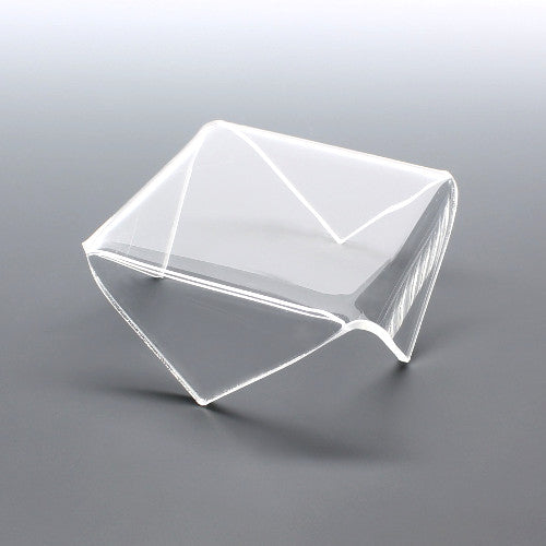 Clear acrylic display riser with pointed corner folds for displaying items